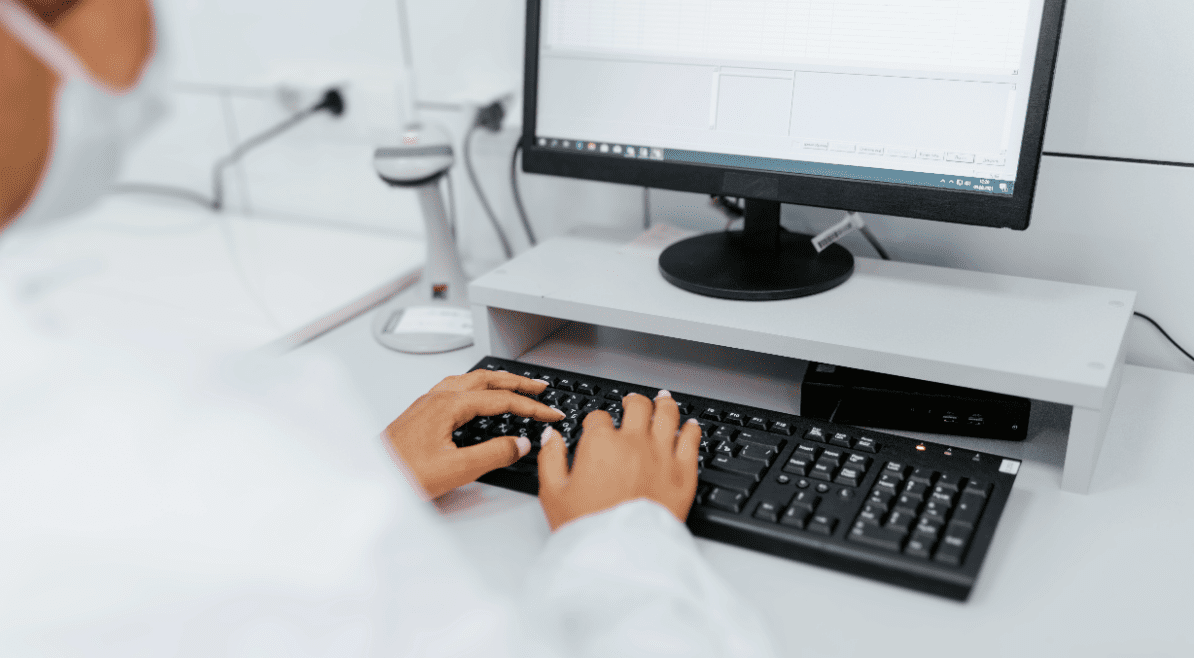 Medical scientist typing at computer